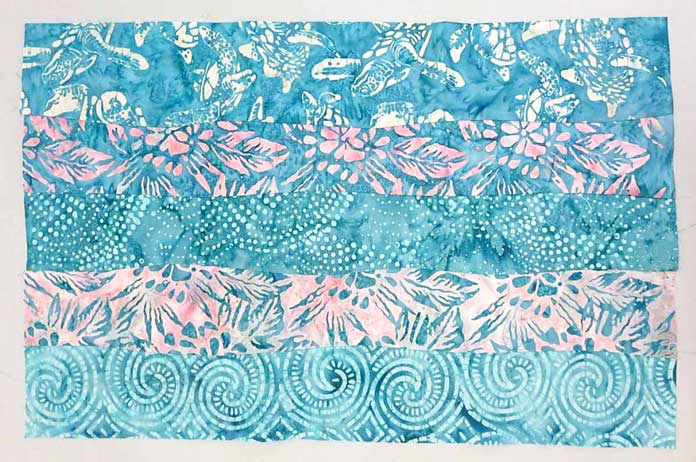Completed curve pieced strip set with seams pressed to one side; using Banyan Batiks Island Vibes fabrics
