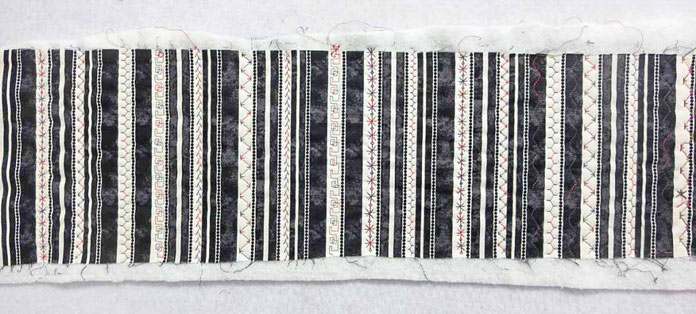 Striped fabric with decorative stitches