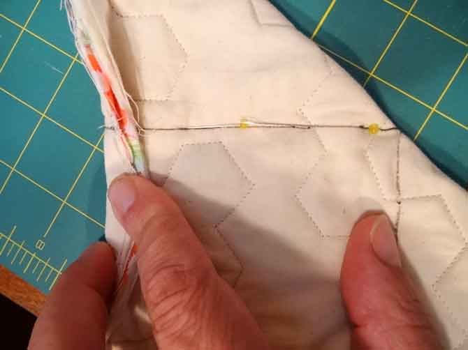 Fold short edge to long edge, match lines and pin