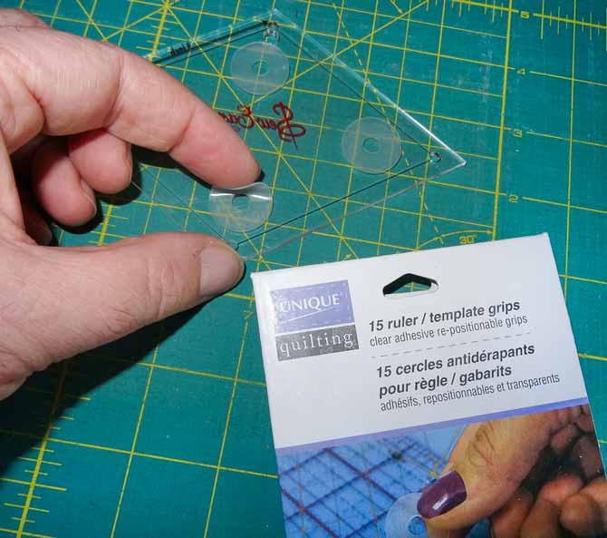 Applying a rubber curcular grip to the bottom of a ruler.