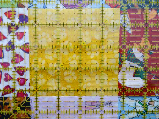 The diagonal line of the OMNIGRID ruler goes from corner to corner and assists in the squaring of a quilt block.