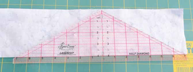 The 4" mark of the SEW EASY Half Diamond Ruler is aligned with the fold of the fabric.