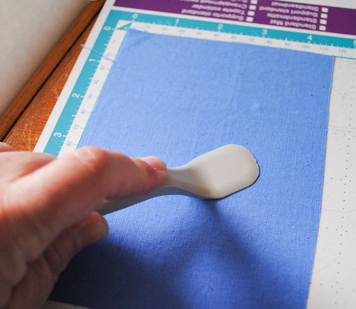 Sticking the fabric to the cutting mat