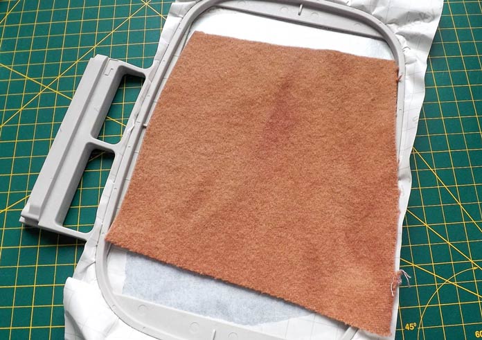 Place the wool felt square on top of the Sulky Sticky + stabilizer and then secure the hoop in the carriage of the Dreamweaver XE.