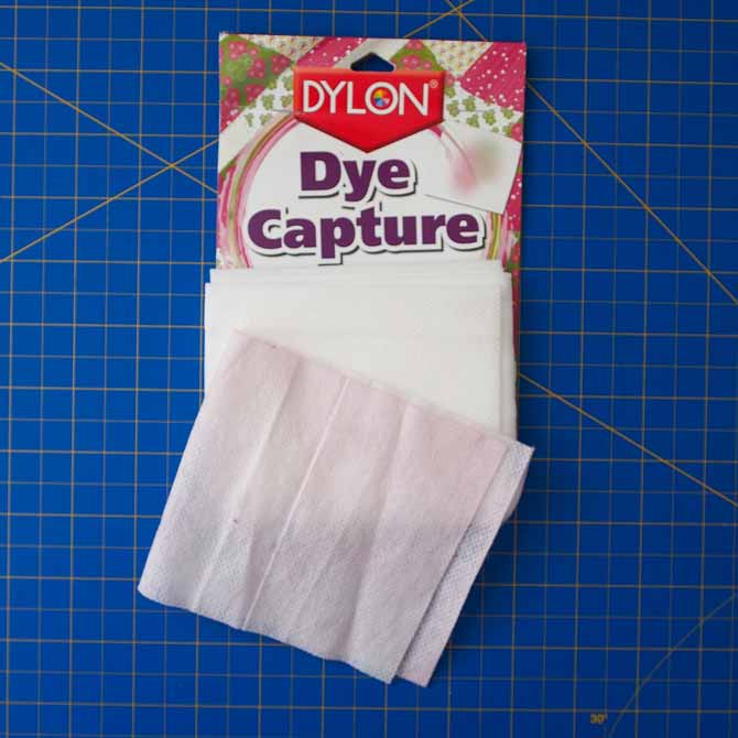 Pink tinged dye capture sheet that captured red dye