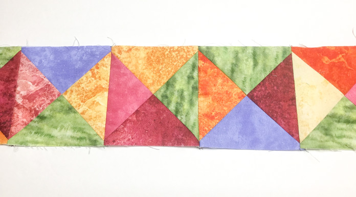 Squares pieced from randomly placed quarter square triangles are sewn together for this fun border. A tutorial on thread painting using SCHMETZ needles/ Gütermann threads / Northcott fabric