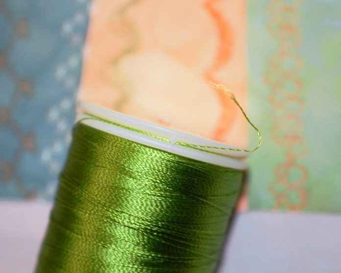 Use these little hooks in the cap of the spool of WonderFil rayon threads to secure the thread tails.