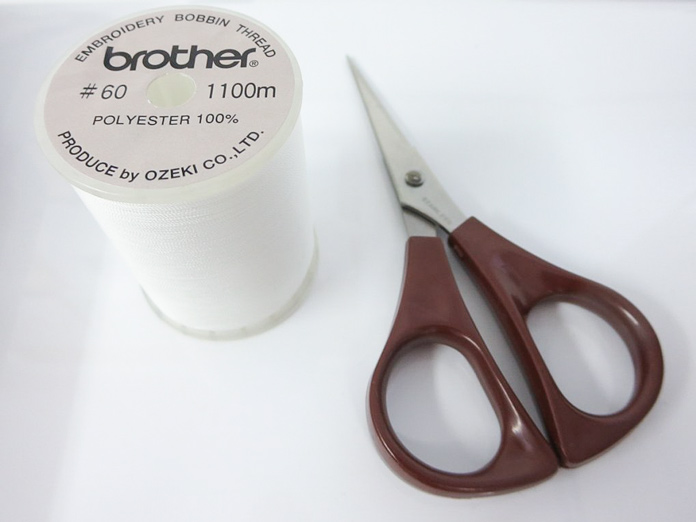 Brother bobbin thread and small scissors come with the machine.