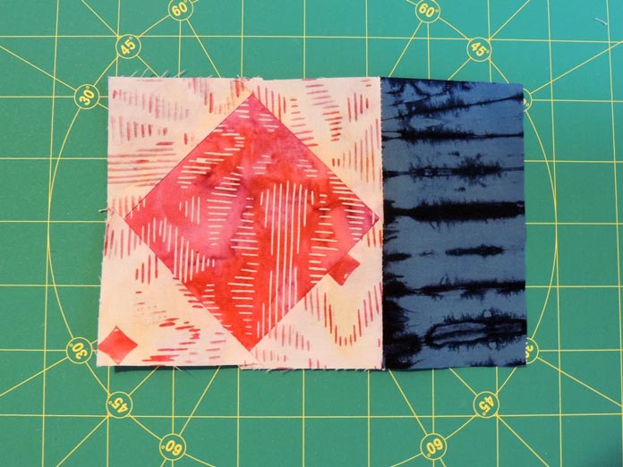 Fabric E strip added to a square in a square unit.