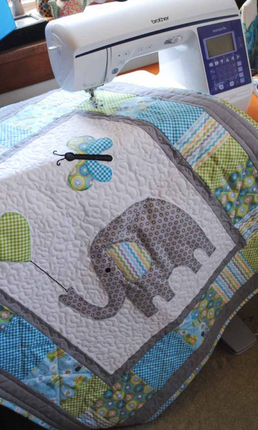 The finished Elephant Baby Quilt shown with the Brother NQ900 sewing machine.