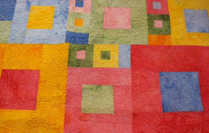 A quilt sample made using a variety of hand dyed fabrics.