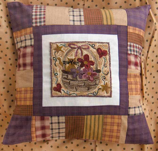 Allie's Basket punchneedle pattern by Christine Baker of Fairfield Road Designs, sewn into a pillow.