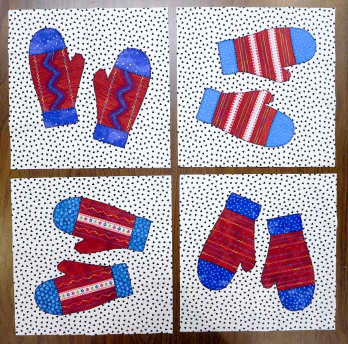4 pairs of mittens are sewn onto background blocks. 