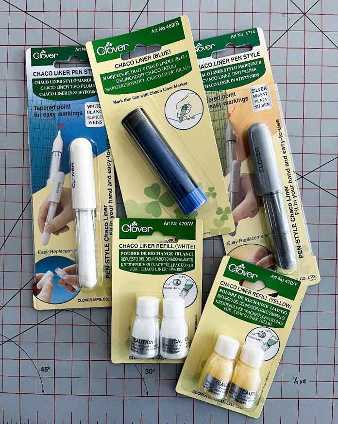 A variety of packaged Clover Chaco liners and refills. Clover Chaco Liner, Clover Quilting Pins, Clover Rotary Cutter