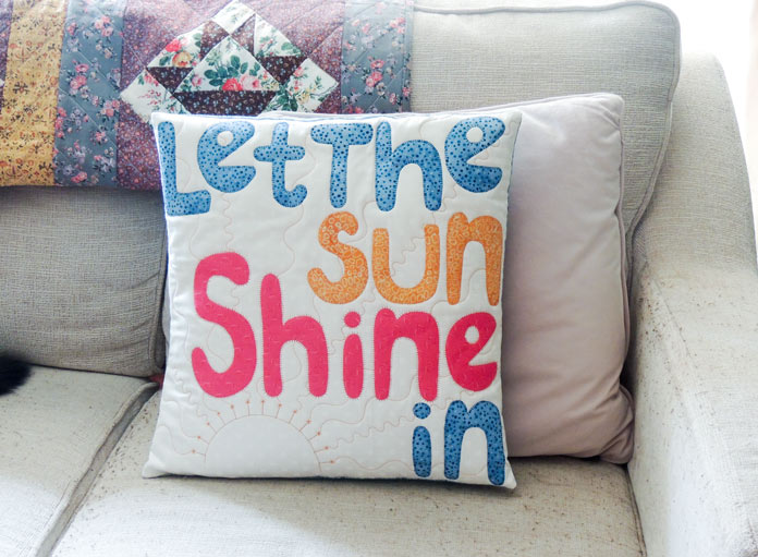 Quilted cushion cover for spring that says ‘Let the sun shine in’