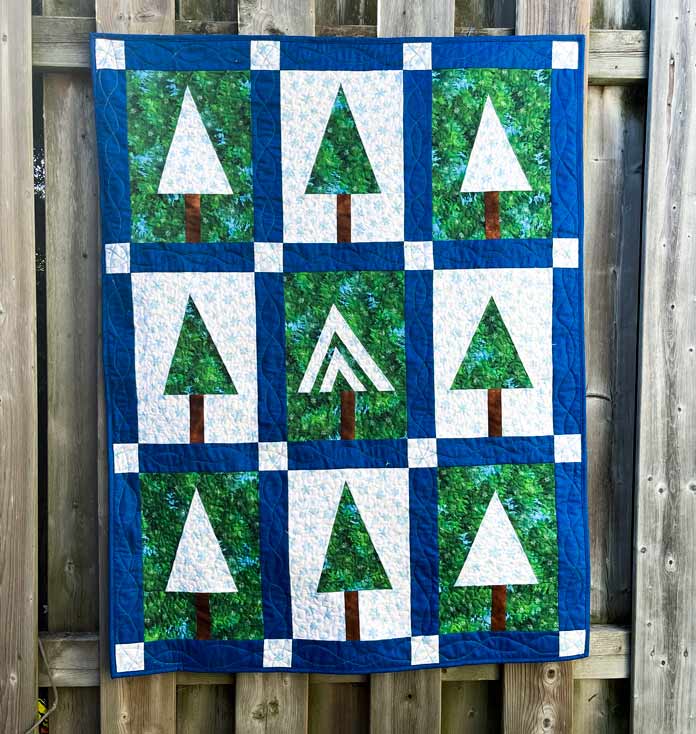 A quilt made using trees as the main motif