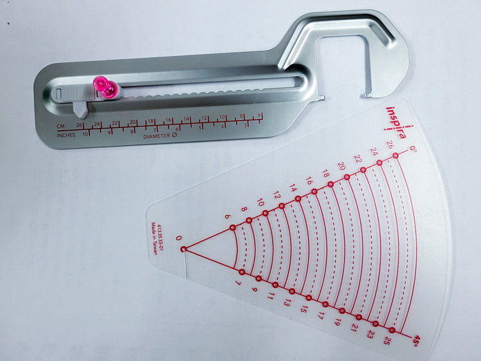 A long metal sewing machine attachment and a plastic template with red lines; Husqvarna Viking Circular Attachment