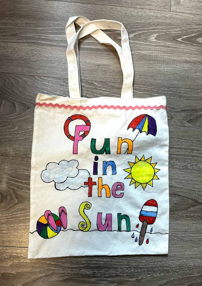 An embellished beach tote with the words ‘fun in the sun,’ and painted beach balls, flip flops, sun, popsicle, clouds, beach umbrella and a swimming ring, Monte Marte Signature Fabric Art Set, Gütermann Thread
