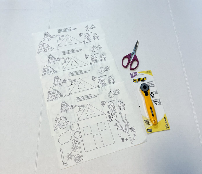 4 pages of HeatnBond EZ Print Lite Iron-On Adhesive sheets with the Circle the Seasons Table Topper applique details printed on the paper side so that they are ready for cutting with paper scissors or an OLFA 28mm rotary cutter 