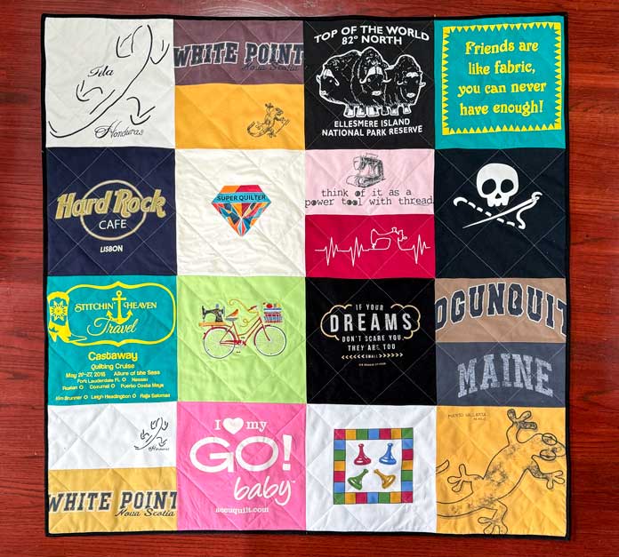 A T-shirt quilt made with 16 squares measuring 48” x 48”.