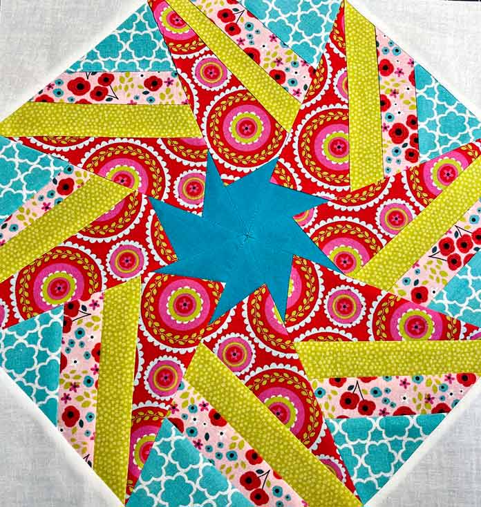 Kaleidoscope block 1 with 4 colors of triangle pie pieces, turquoise star center and white corner pieces made with cotton fabric, Free Kaleidoscope Quilt Block Pattern