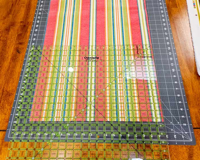 A striped fabric under a large quilter's square ruler; Husqvarna VIKING Opal 690Q, OMNIGRIP 20½" Square Ruler, HeatnBond, Chaco Line