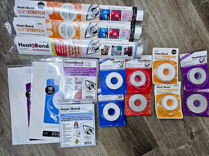 A variety of packaging of HeatnBond fusible web products; HeatnBond Hem, HeatnBond SoftStretch Fusible Web, HeatnBond Lite, HeatnBond Feather Lite, HeatnBond Ultrahold, sewing tutorials, quilting tutorials