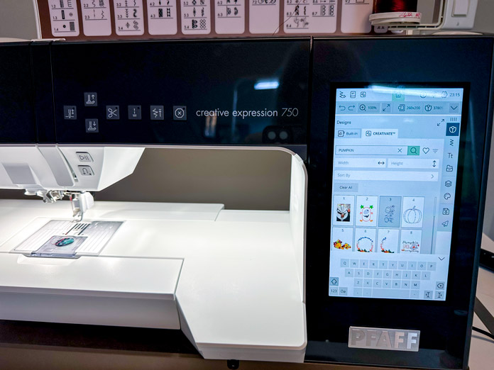 A black and white embroidery machine with a large screen showing the CREATIVATE Catalogue open and searching for pumpkin endless designs for the runner.