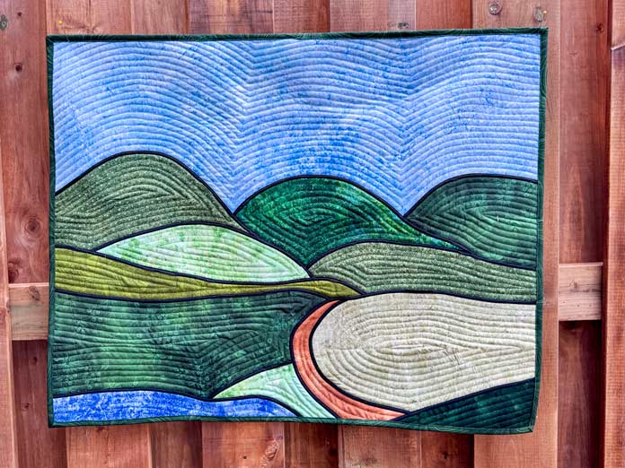 A wall quilt landscape.
