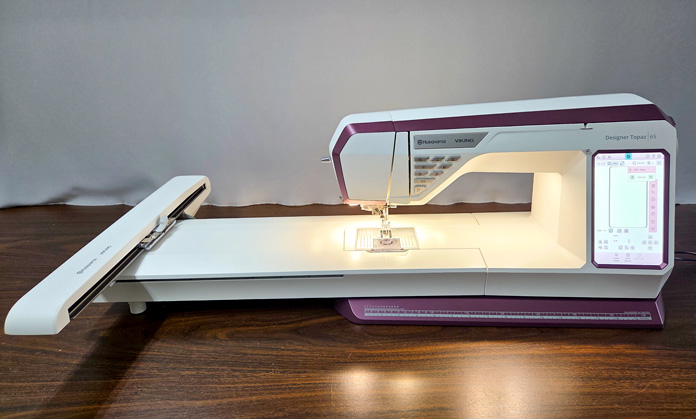 A white and burgundy embroidery machine; Husqvarna VIKING Designer Topaz 65