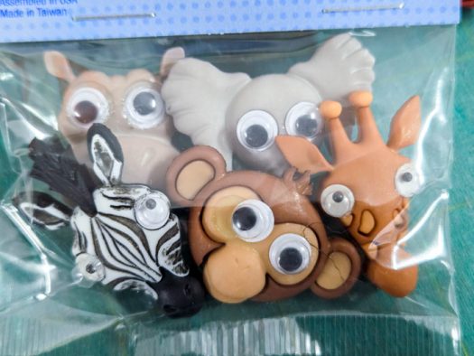 Five zoo animal buttons with googly eyes