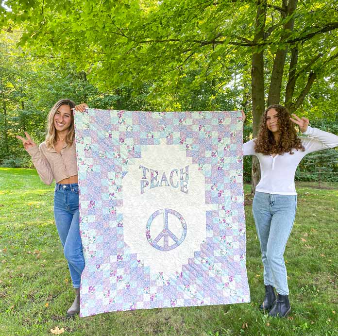 Teach Peace Flower Power Quilt by Clodagh Coker was featured in ANPTmag Issue 57; photo by Carla A. Canonico for ANPTmag