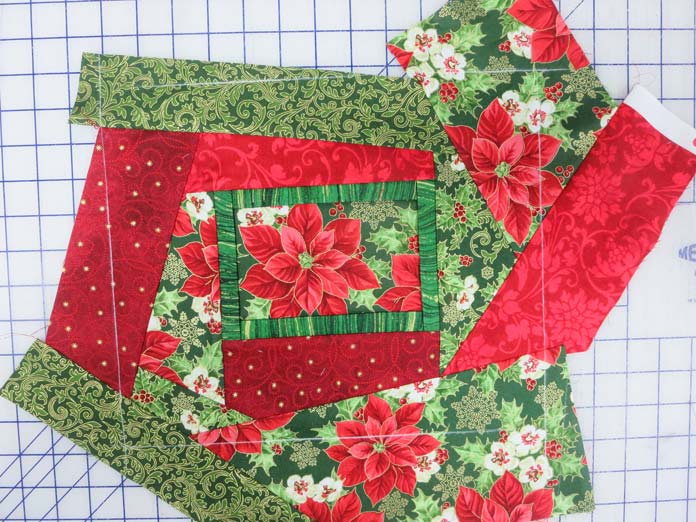 The Pop-Out Picture quilt top in red and green fabrics is ready for decorative stitching; Brother NQ700, Brother BQ3050, HeatnBond Feather Lite, Brother SA185 ¼" Piecing Foot-Guide, Brother SA125 ¼" Quilting Foot, SULKY Heidi Lund's Life in the Tropics Cotton Blendables Thread Collection