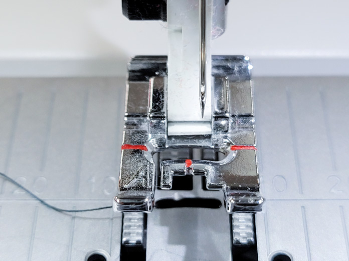 A metal presser foot for a sewing machine and a needle that is off center; Husqvarna Viking Tribute 150C