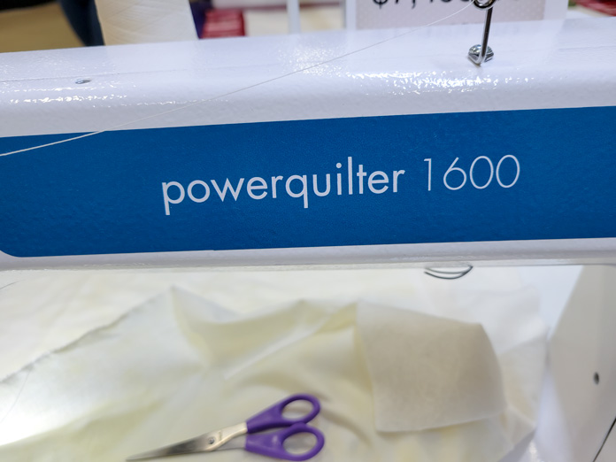 The name of a teal and white sit-down quilting machine, powerquilter 1600; PFAFF powerquilter 1600