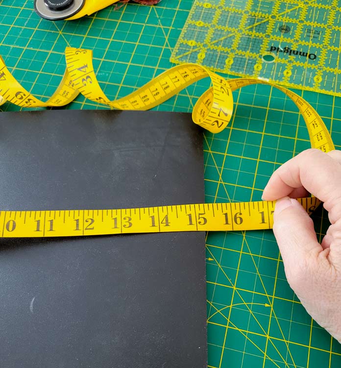 A yellow tape measure on a black journal