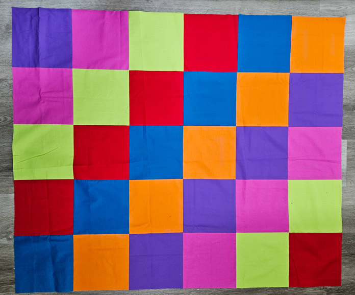 A quilt of multi-colored fabric squares 