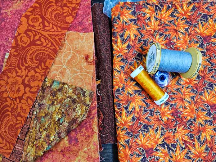 Orange fabric and two spools of thread