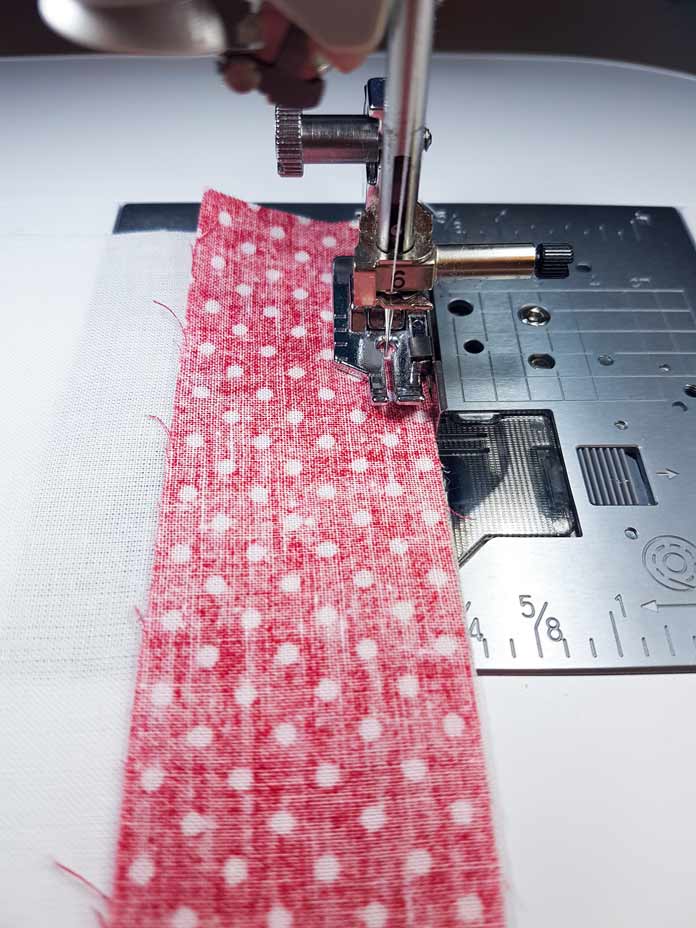 Strips of fabric being sewn by sewing machine using the ¼" piecing foot included with Brother Luminaire 2 Innov-ìs XP2 Sewing, Quilting and Embroidery Machine.