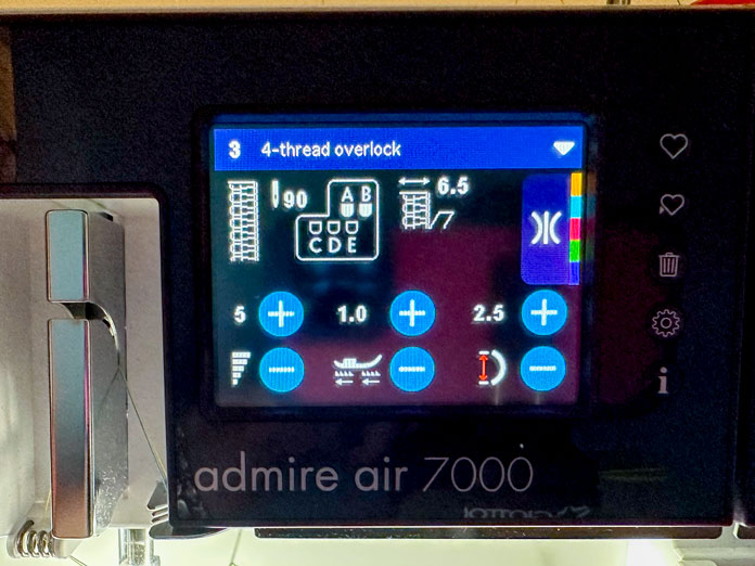 Close-up of the black computer touch screen located on the front of the purple and white serger; PFAFF admire air 7000