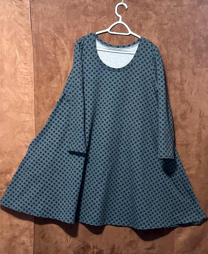 Black polka dots on charcoal gray knit fabric sewn into a long sleeve swing long T-shirt or dress with a scoop neck