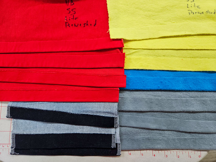 Red, blue, yellow, and gray fabrics with a hem; HeatnBond, fusible web, sewing, applique, quilting, hemming, fabric adhesive, SoftStretch, Lite, Featherlite, Ultra, sewing tips, crafting, fabric experiments