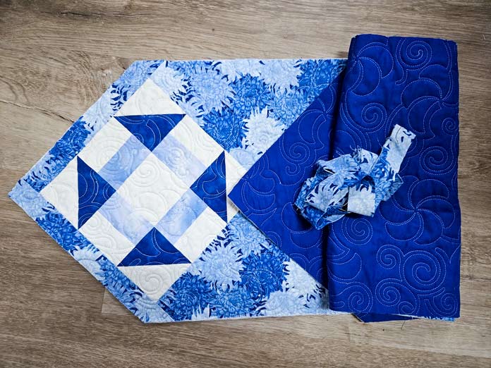 A blue and white table runner and binding