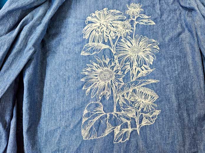 White stitching on a blue shirt