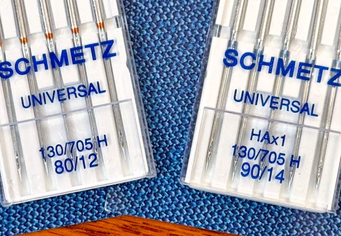 Two packages of SCHMETZ Universal needles, one package is size 80/12 and the other is size 90/14. 