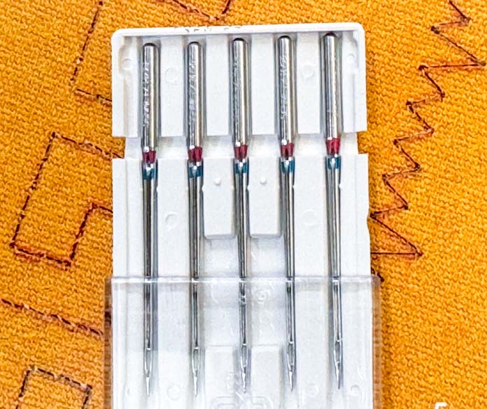 Five SCHMETZ need with color strip showing.