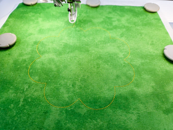 Yellow stitching on green fabric