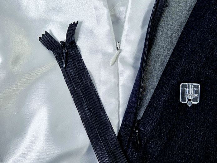 A white dress with an invisible zipper, a black invisible zipper, and a clear invisible presser foot