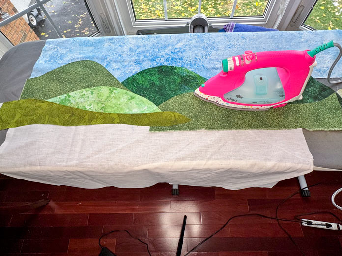 Multiple pieces of fabric are secured to the HeatnBond interfacing with the help of the Oliso Pro iron.