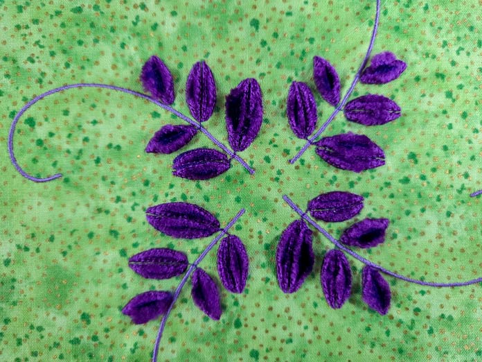 Purple stitching on green fabric